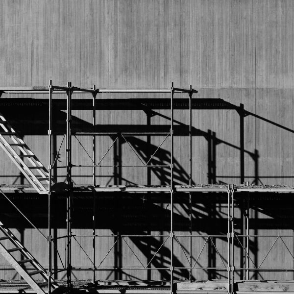 grayscale photography of piled racks